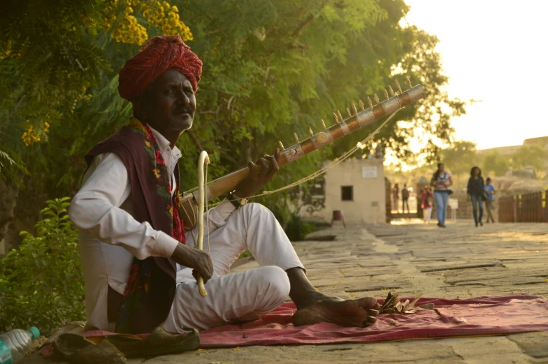 an old man playing music on the ground