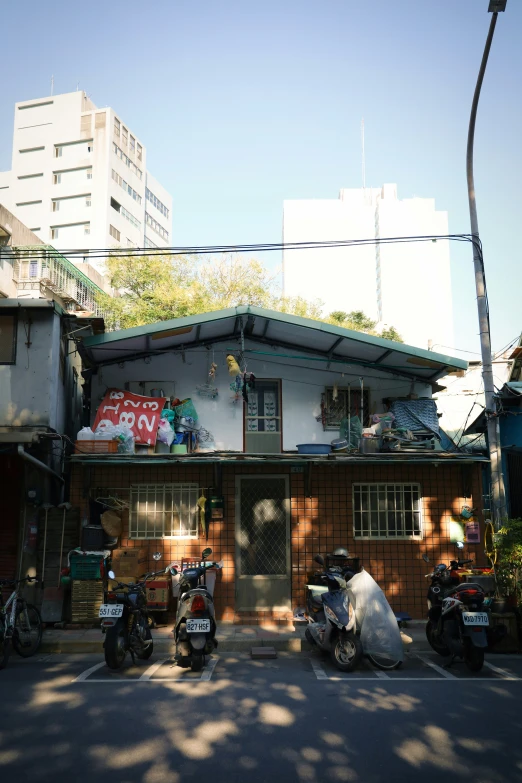 a row of motor bikes sitting outside of a building