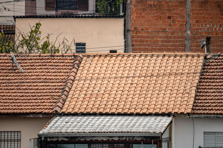 an open umbrella on top of a tiled roof