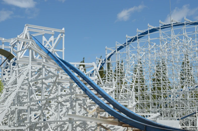 a large white roller coaster going down the hill