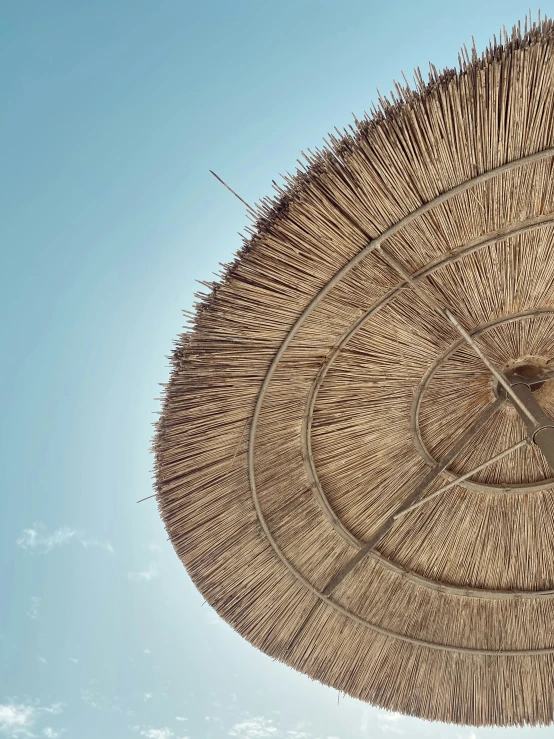 a large parasol is shown with some blue sky in the background