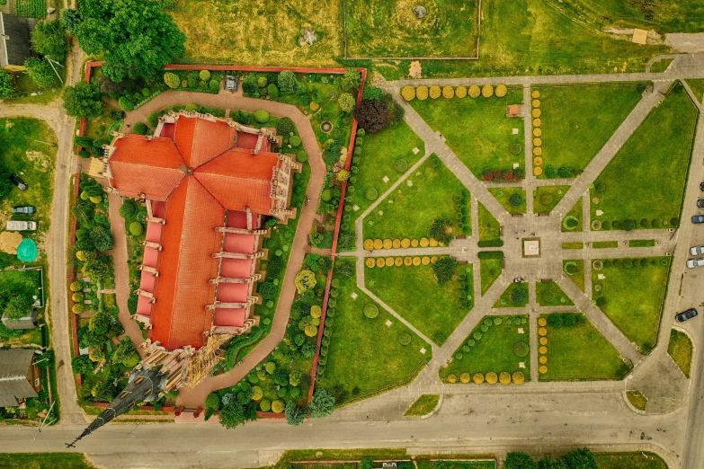 an aerial s of a garden surrounded by trees and grass