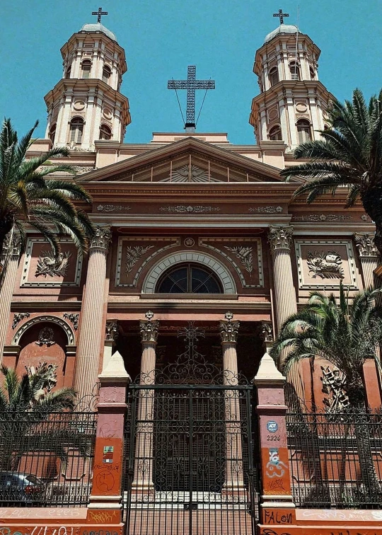 a church with tall towers and a gated entry