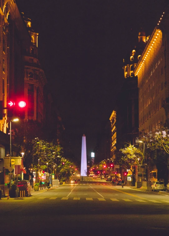 a picture of a street with cars driving down it