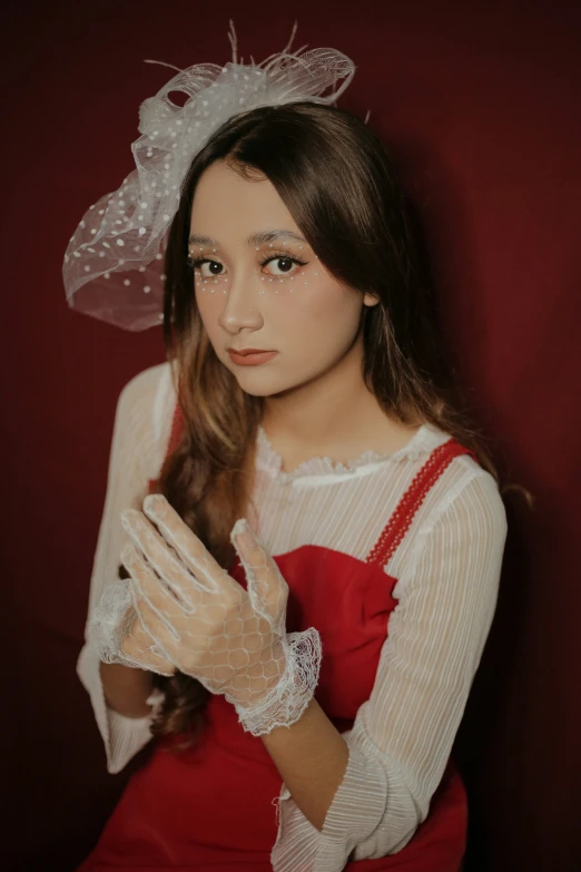 a girl in red dress and white gloves