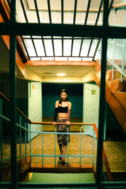 a woman posing on stairs in front of a building