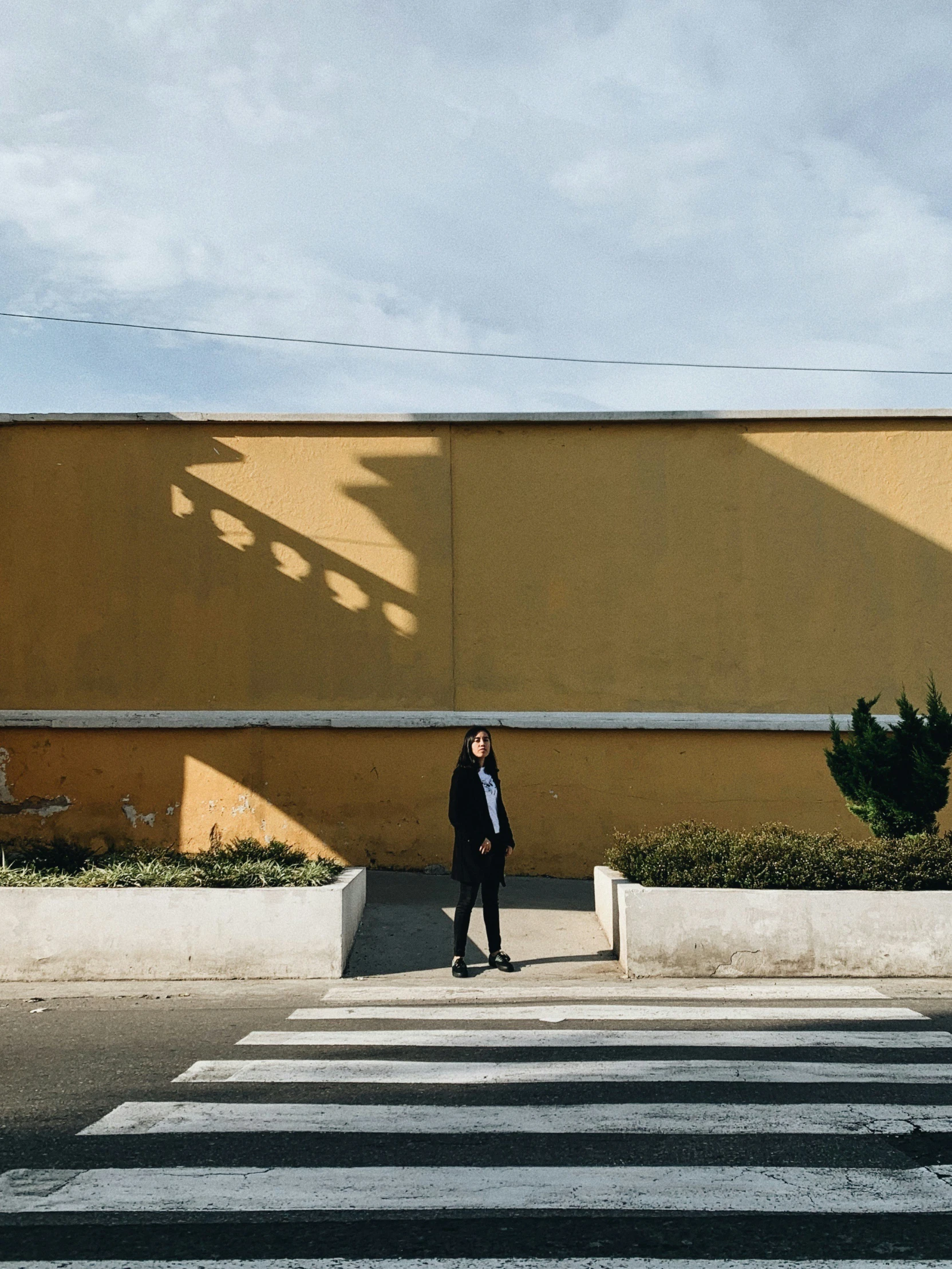 the man in a suit is standing in front of a crosswalk