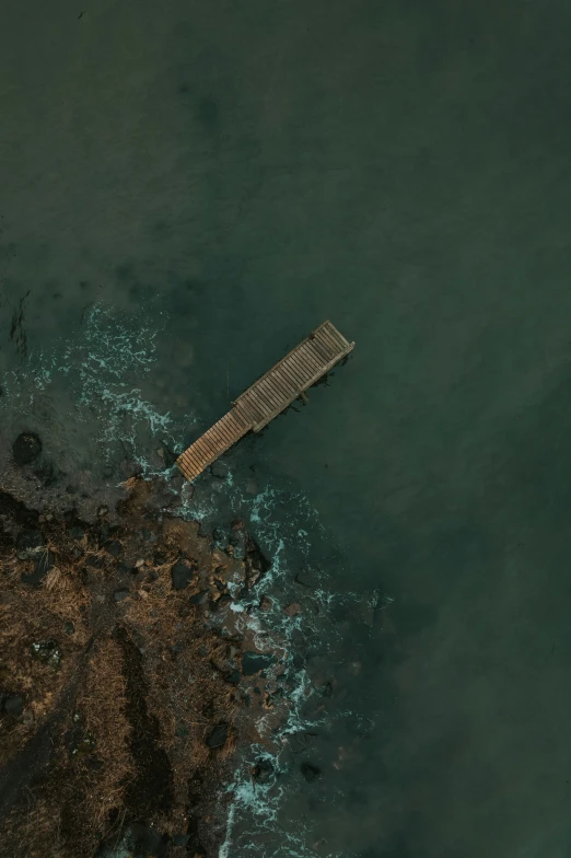 aerial view of jetty in lake surrounded by water