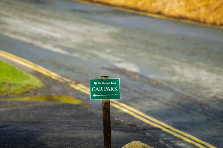 a street with a sign and grass on it