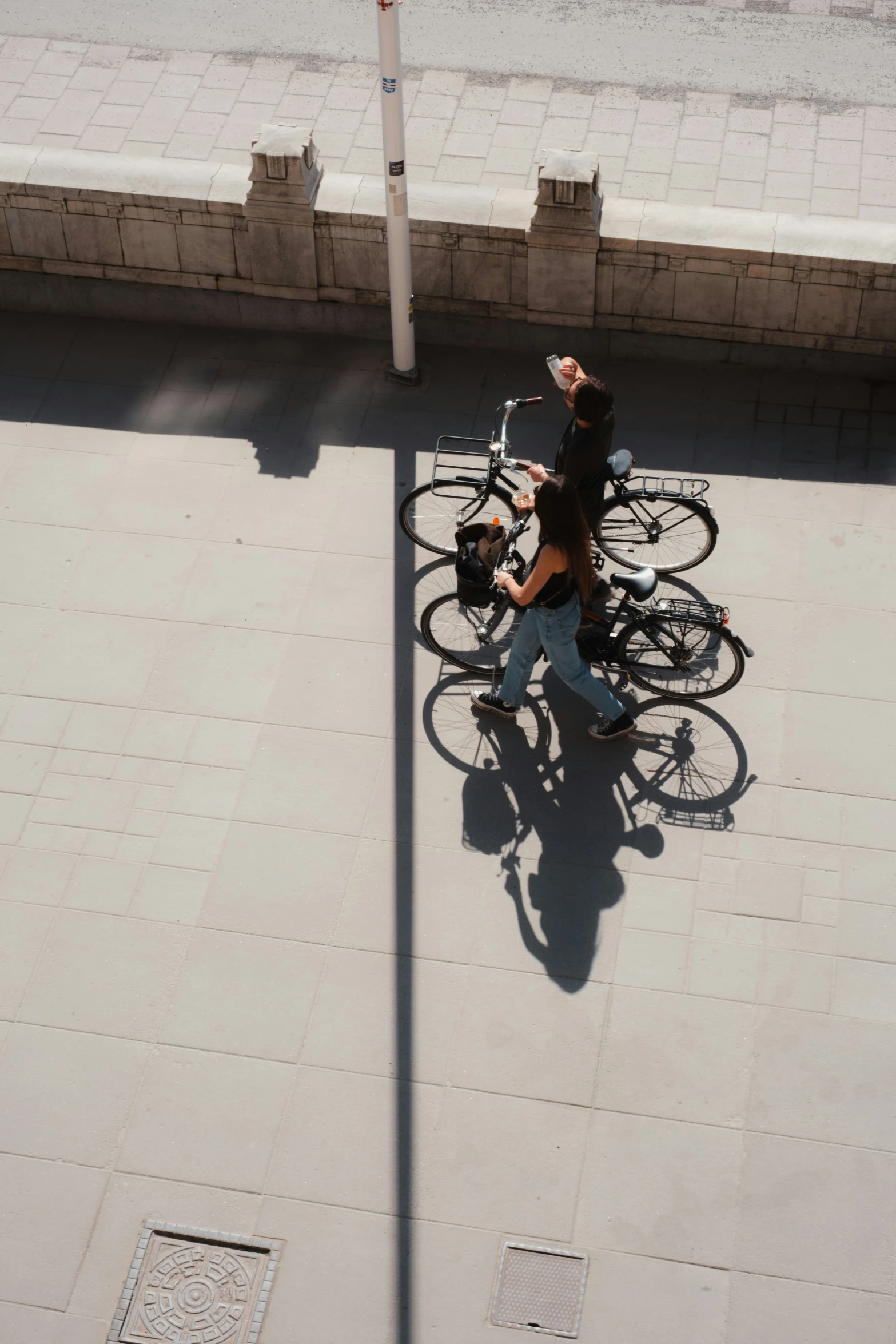 a man standing next to a bunch of bikes parked on the sidewalk