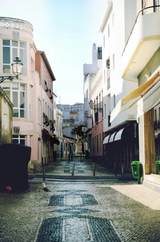 a street with buildings and cars on either side