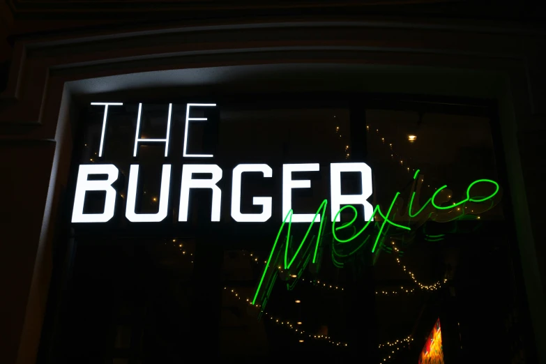 a neon sign in front of a restaurant's entrance