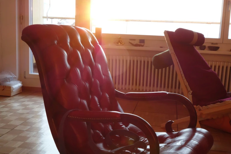 two old leather chairs facing each other in the sun