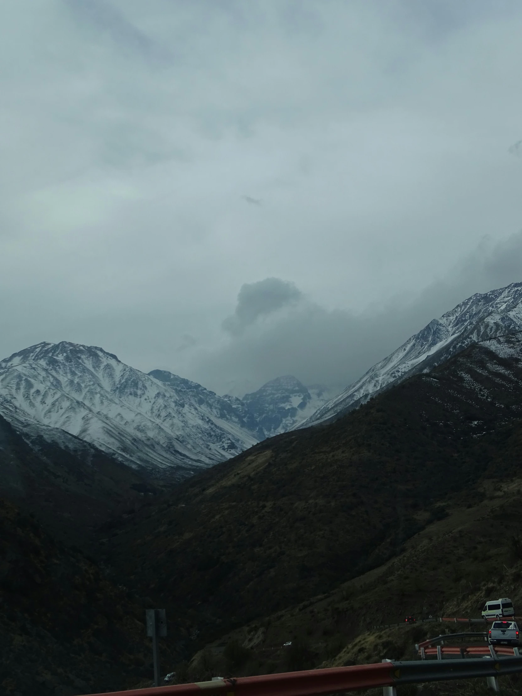 a view of snow - covered mountains from a freeway