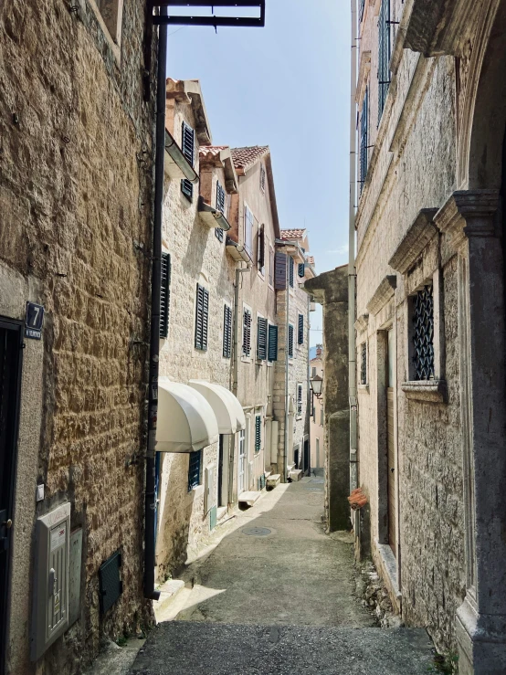 an alley between two buildings in an old town