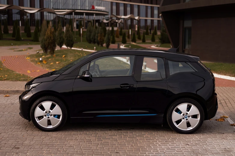 the black car is parked in front of a building