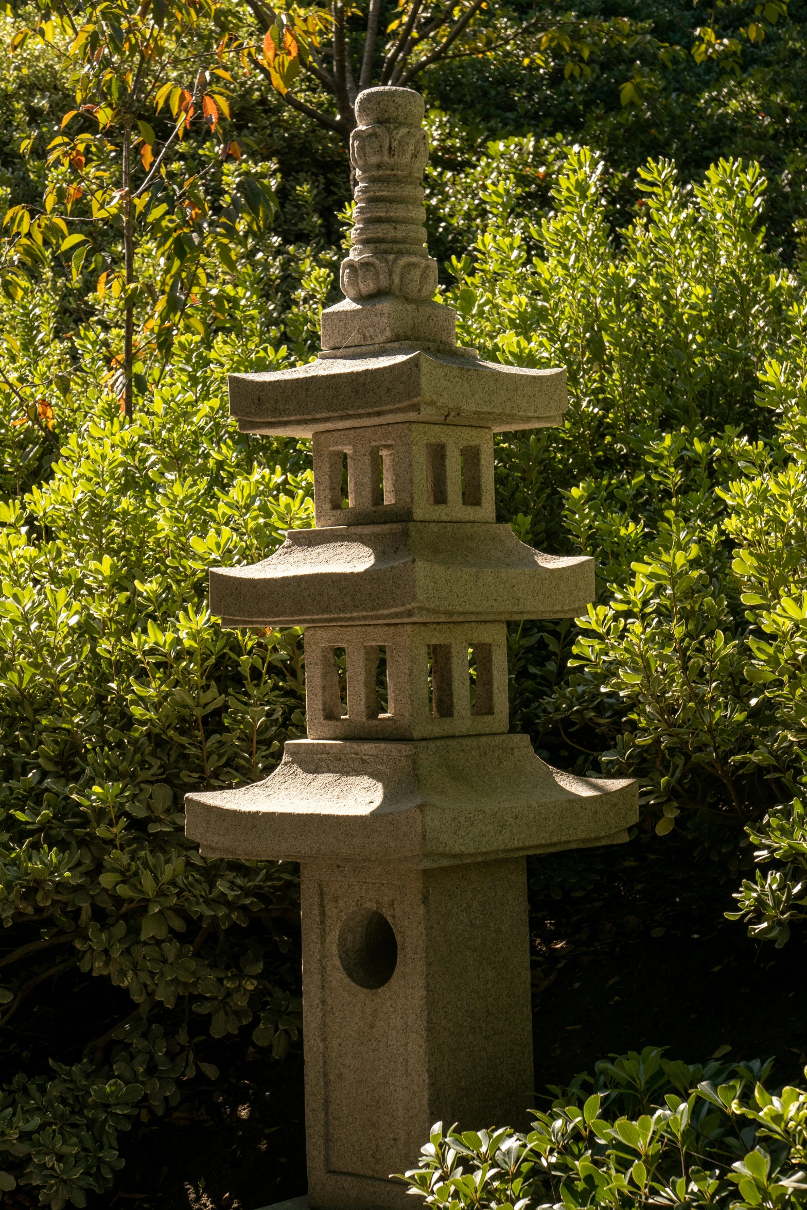 the tall gray stone tower has five candles