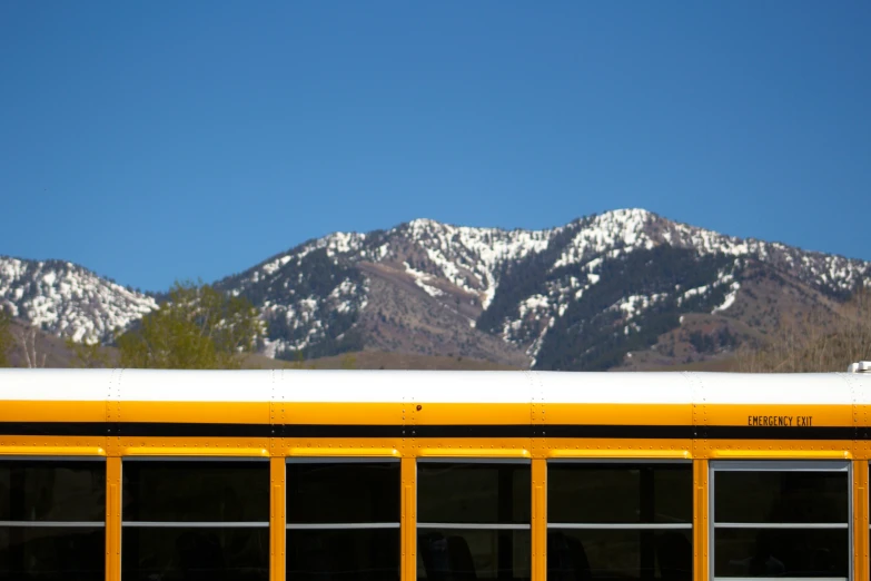 the mountains behind a yellow school bus