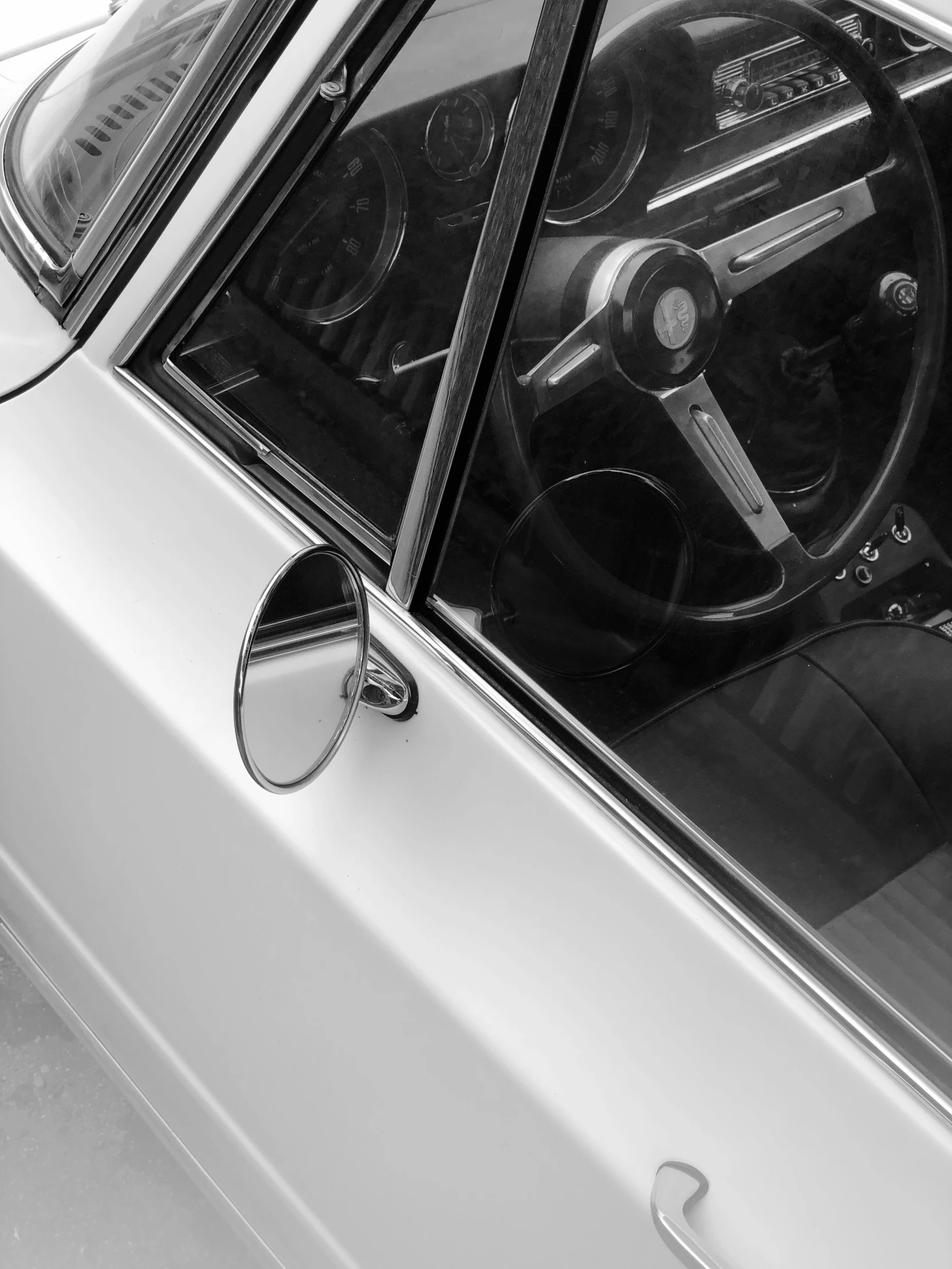 a small white car with the inside door handle open