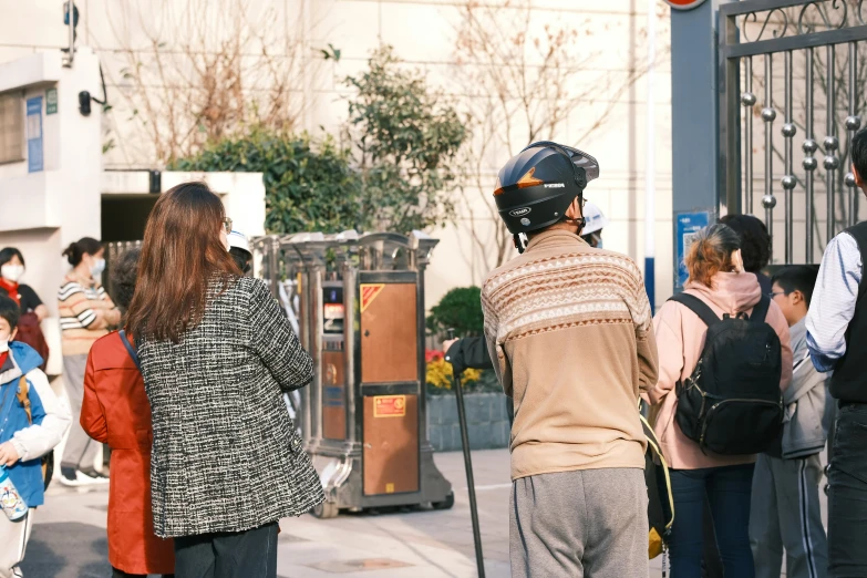 people are standing outside on a city street