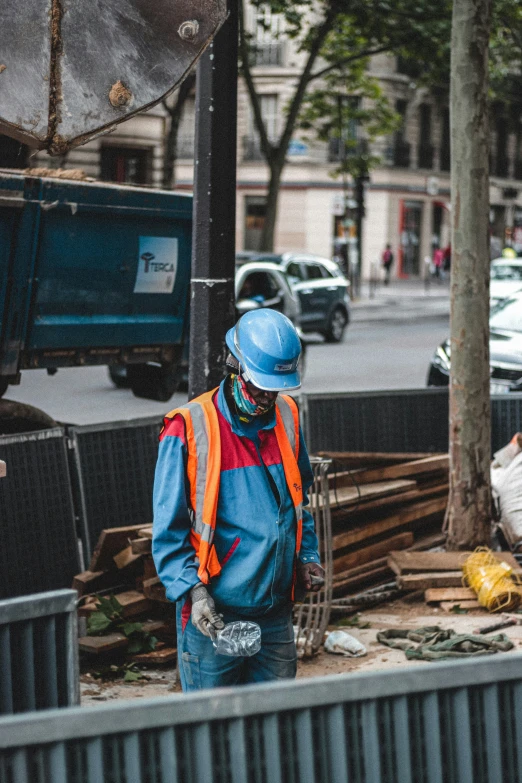 a construction worker on a busy street wearing a safety vest