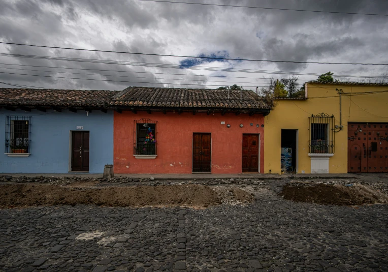 two buildings with red and blue doors and windows