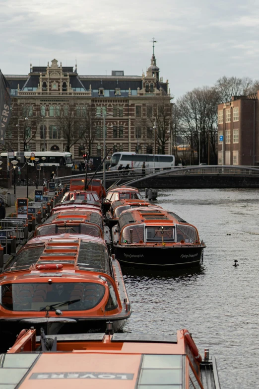 a bunch of boats that are lined up on the side of the river