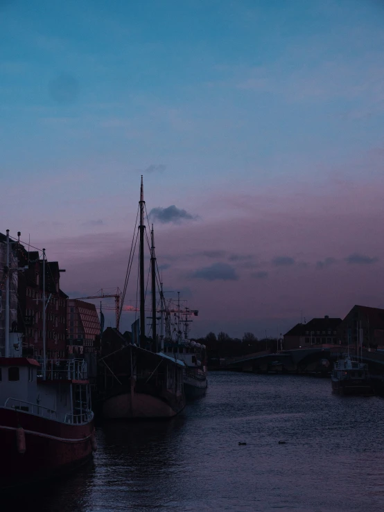 an old fashioned sailboat in the middle of the river