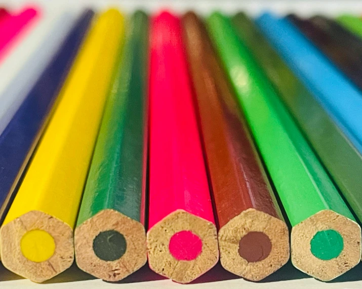 several colored pencils laying side by side