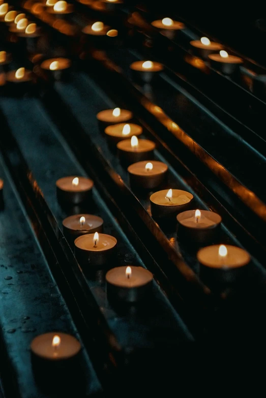 a number of lit candles burning next to each other