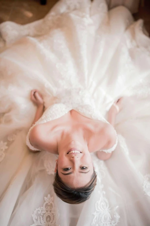 a person laying on a white dress