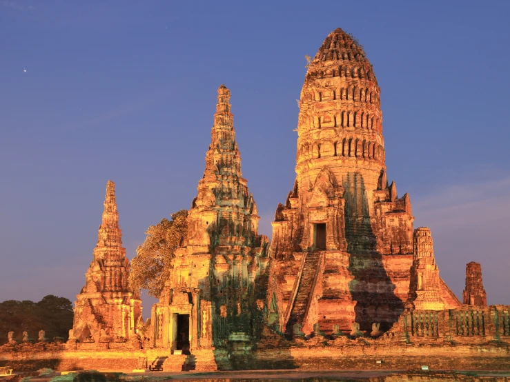 a very large building made of stone with several towers on the side