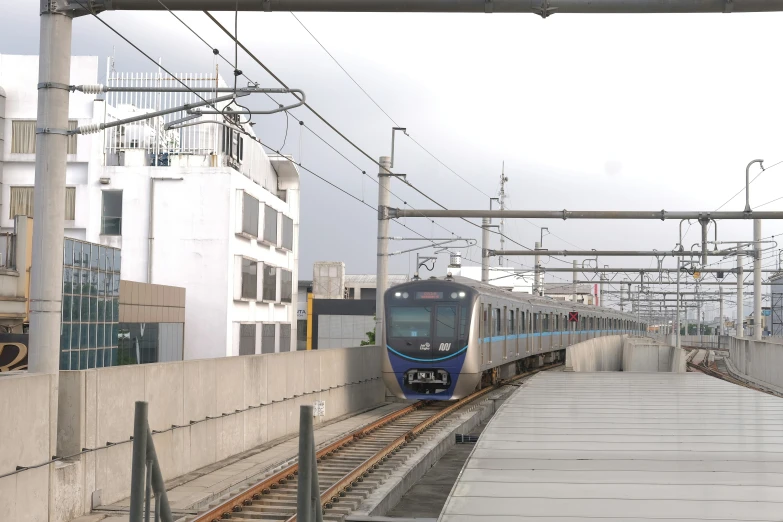 an electric commuter train on the tracks in city