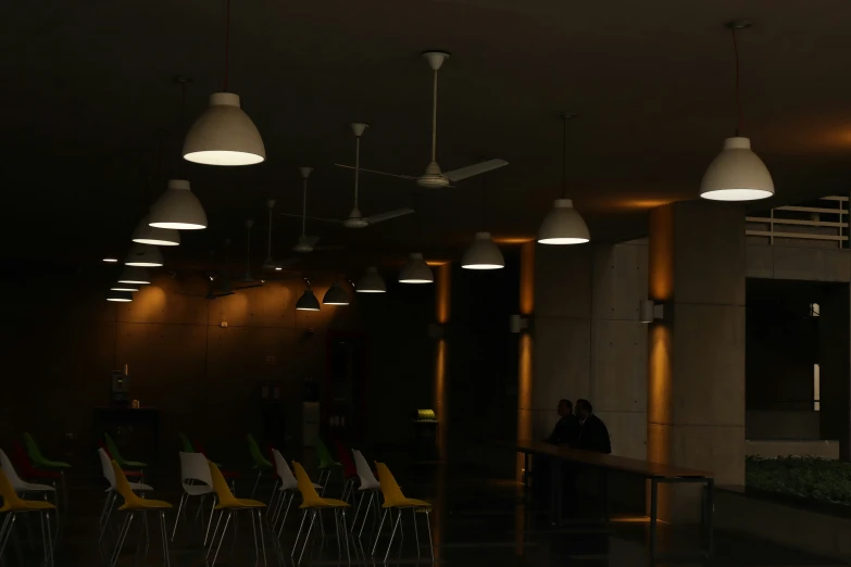 an empty airport lounge with chairs and lights