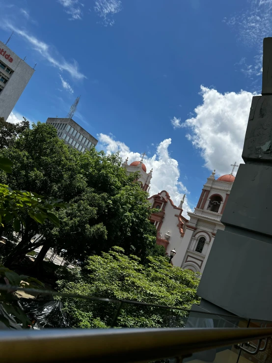 an old building with some towers and sky above