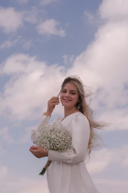 a woman with blonde hair holding flowers