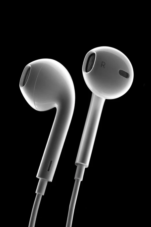 a pair of ear buds sitting next to each other