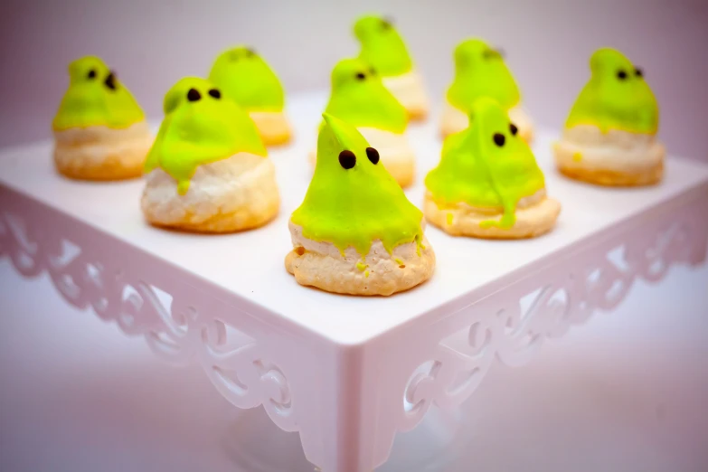 halloween cookies are on the tray with green icing