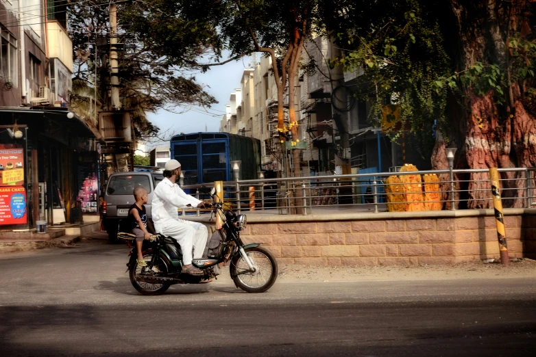 a man on a motorcycle driving down the road