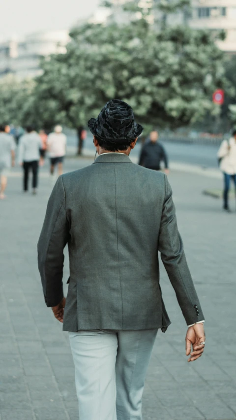 a man in a suit walking across a street