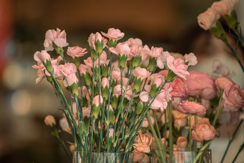 flowers are in vases on the table