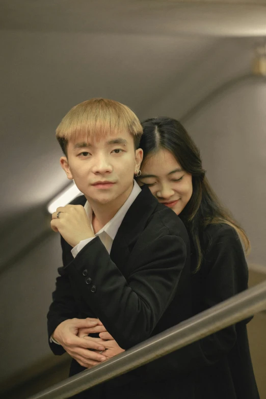 an asian couple are going down an escalator together