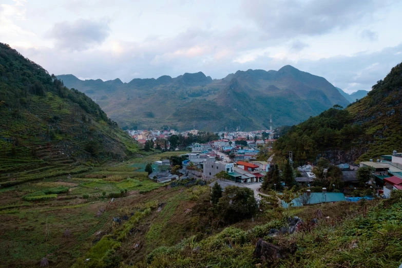 an aerial view of a village surrounded by hills