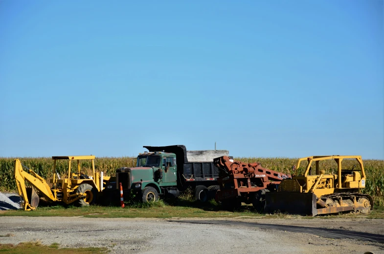 an old pick up truck sitting in front of some equipment