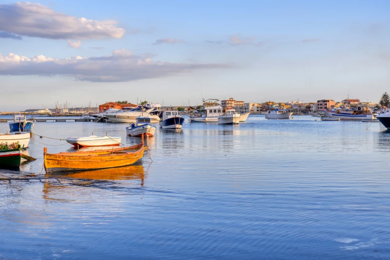 multiple boats docked in the harbor during the day