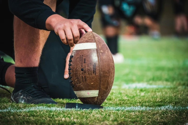 a football sitting on top of a lush green field