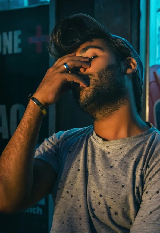 a man with glasses, and a watch on his face talking on a cell phone