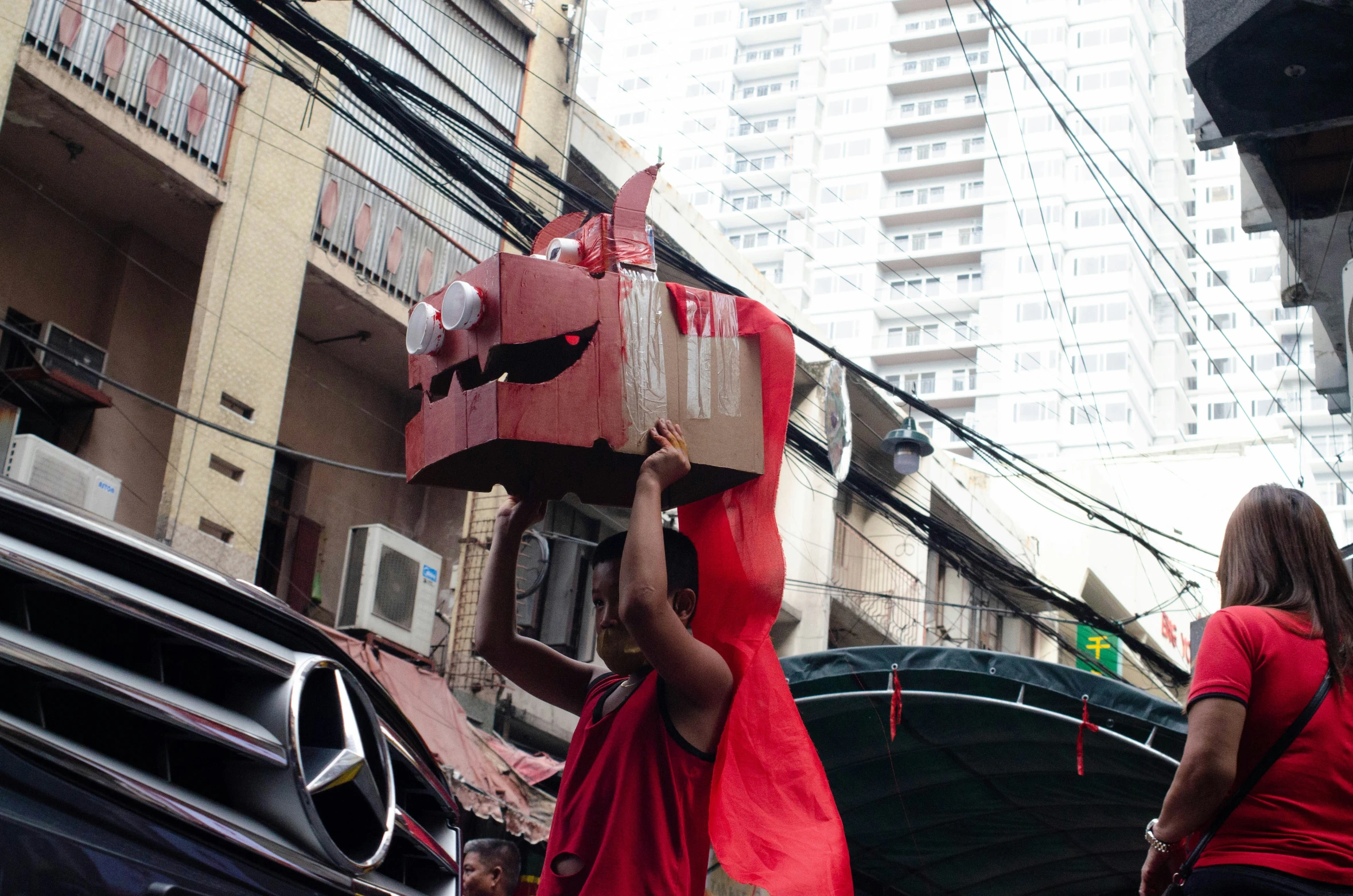 the woman is carrying a giant piece of paper on her head