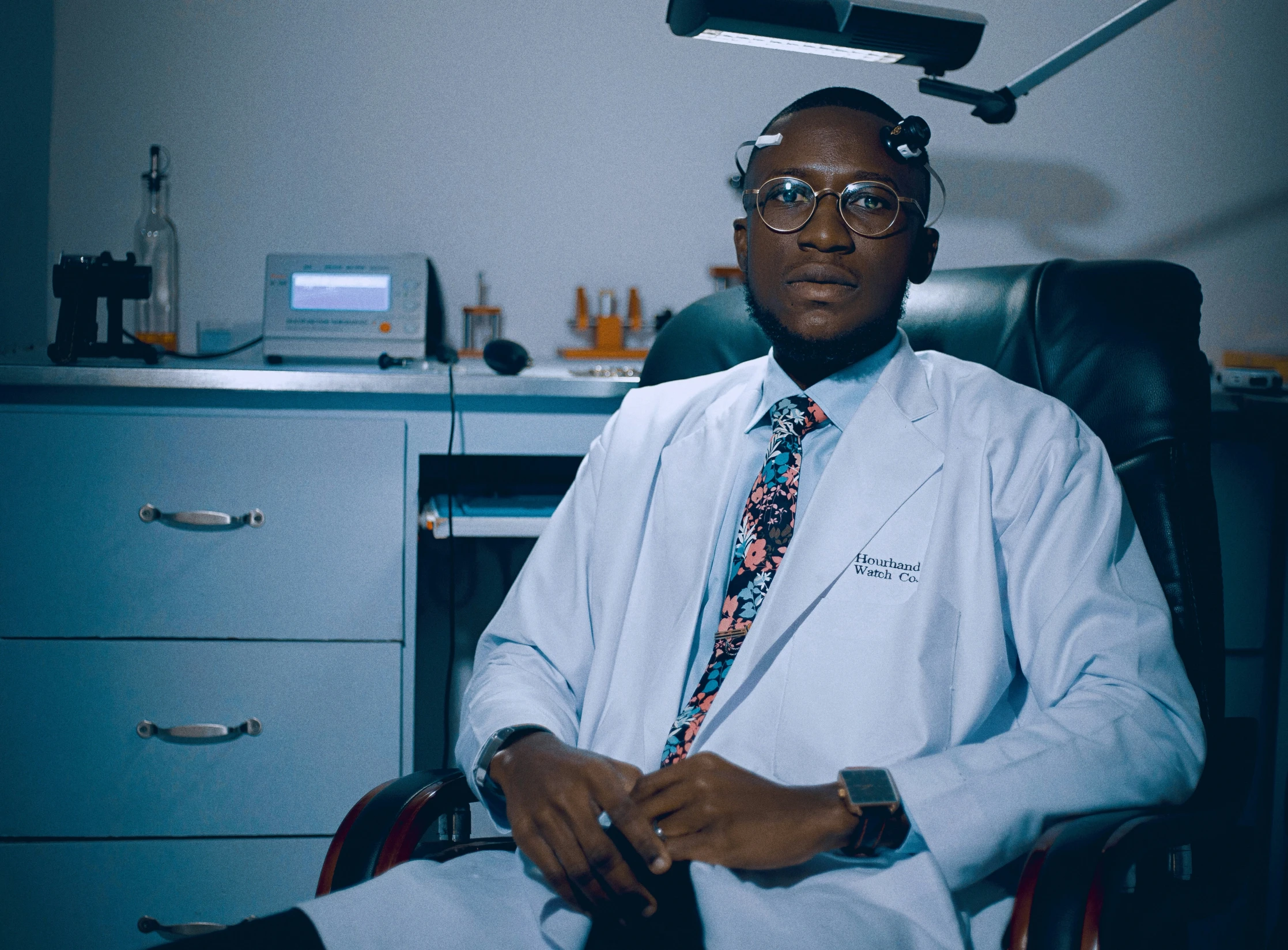 a man wearing a suit and tie posing for a po in his chair