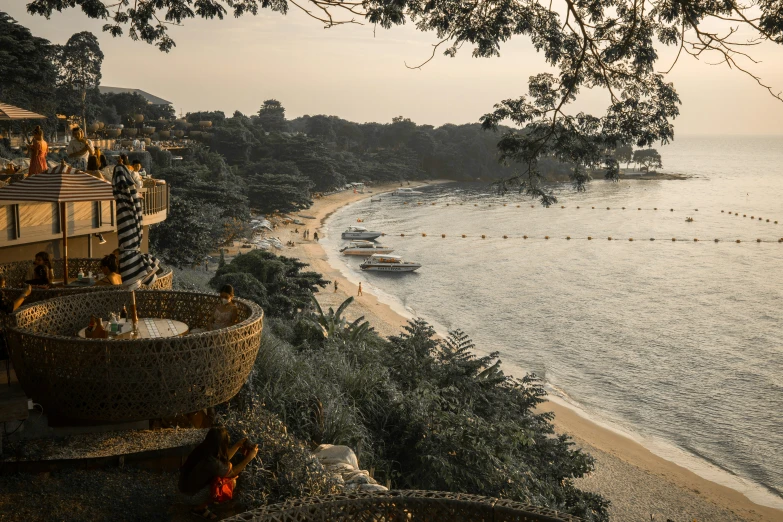 people are relaxing in chairs overlooking a secluded beach